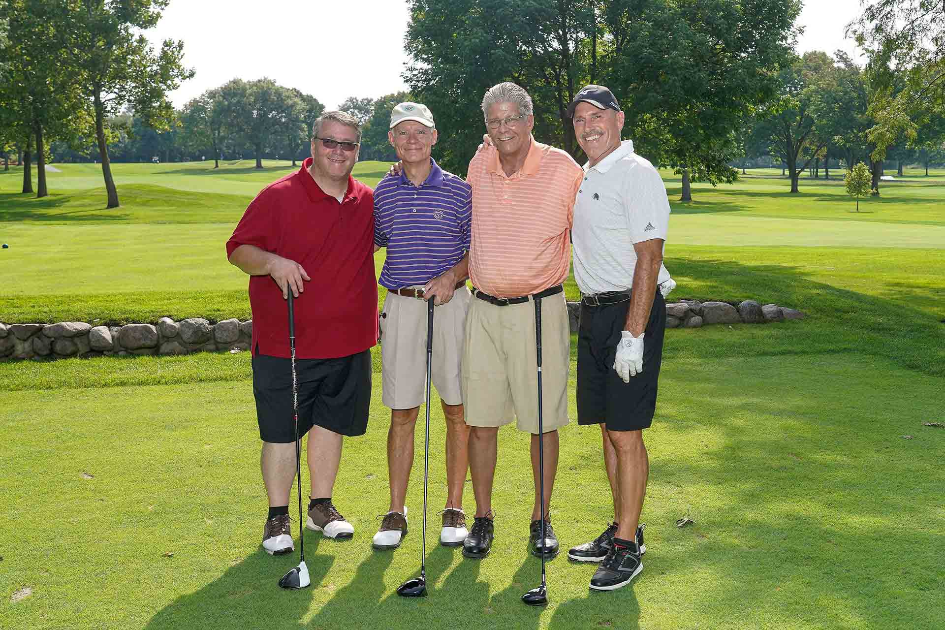 2019-endowment-classic-four-men-smiling-on-golf-course