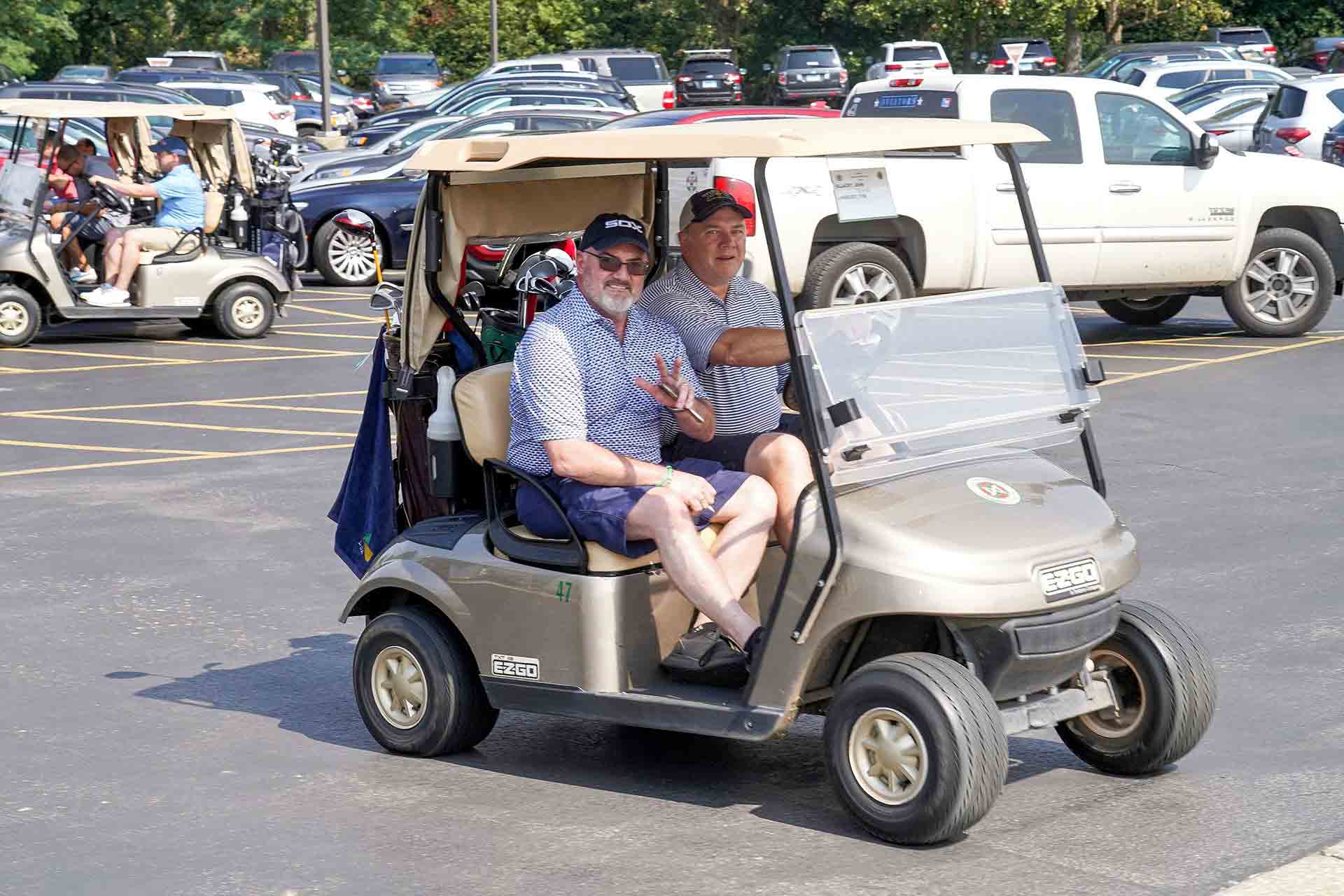 2019-endowment-classic-man-waving-in-golf-cart