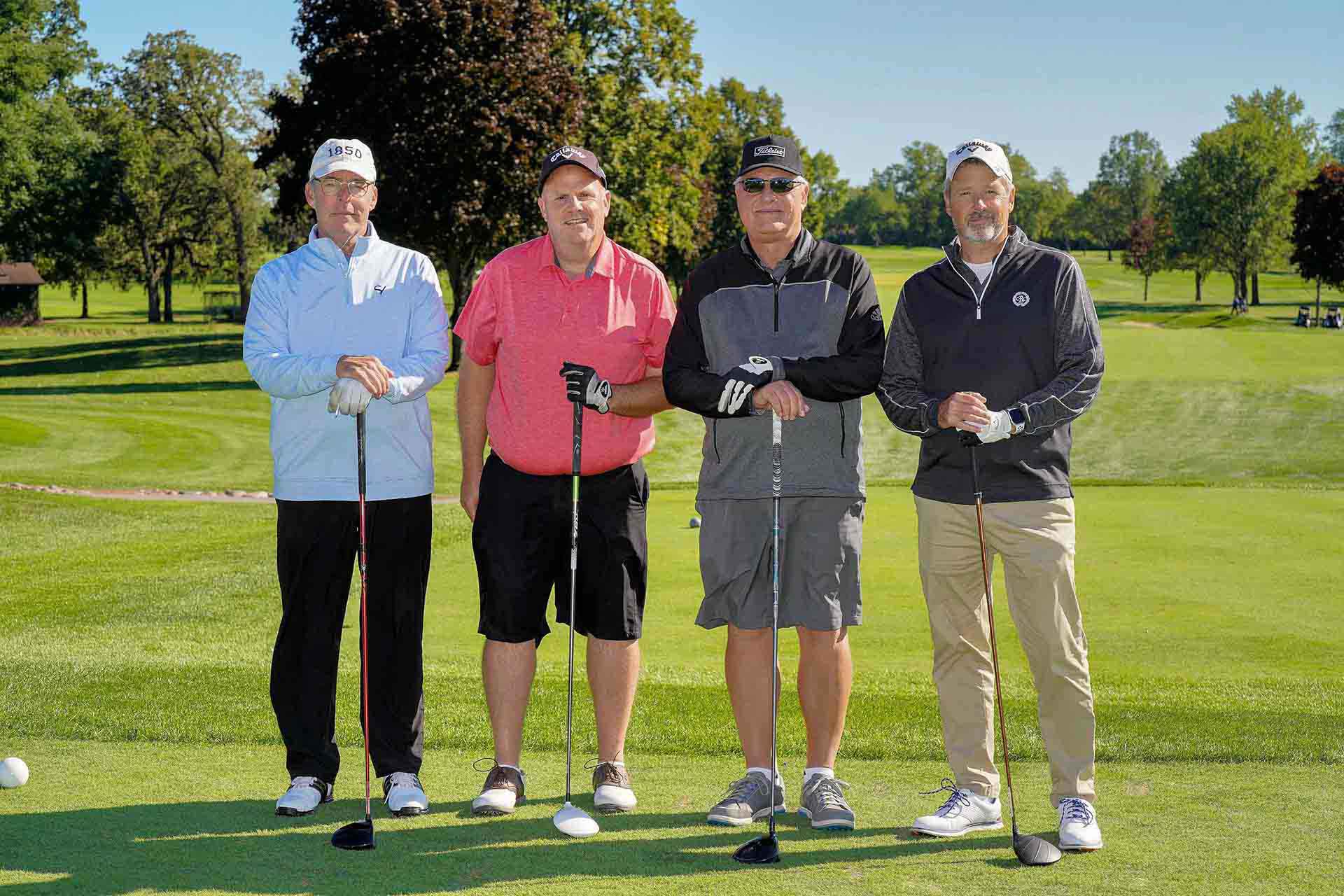 2020-endownment-classic-four-golfers-smile-on-golf-course