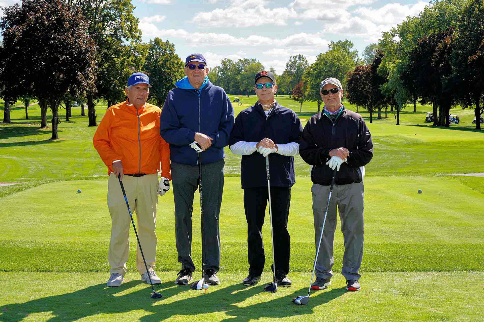 2020-endownment-classic-four-people-on-golf-course-smile-for-photo