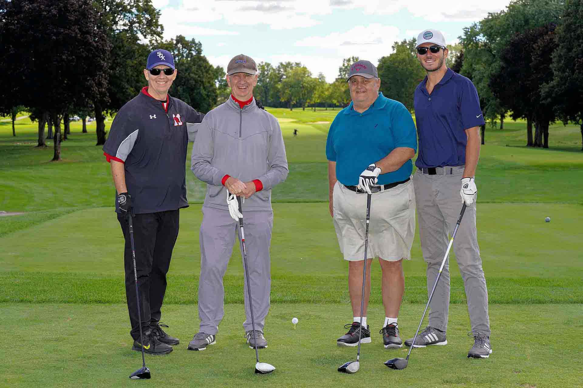 2020-endownment-classic-four-people-smiling-for-photo-on-golf-course