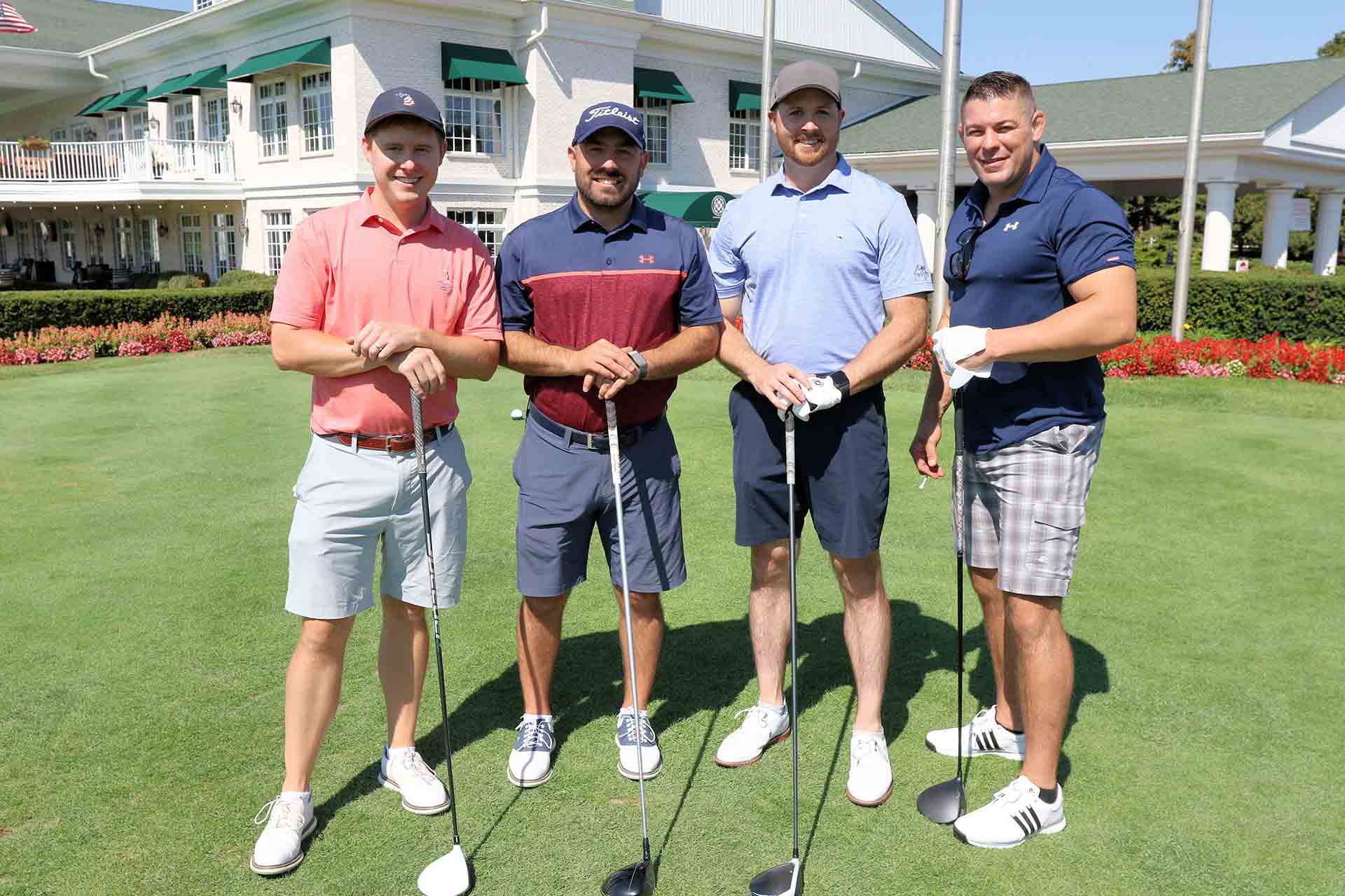 2021-endowment-classic-four-people-posing-together-with-clubs