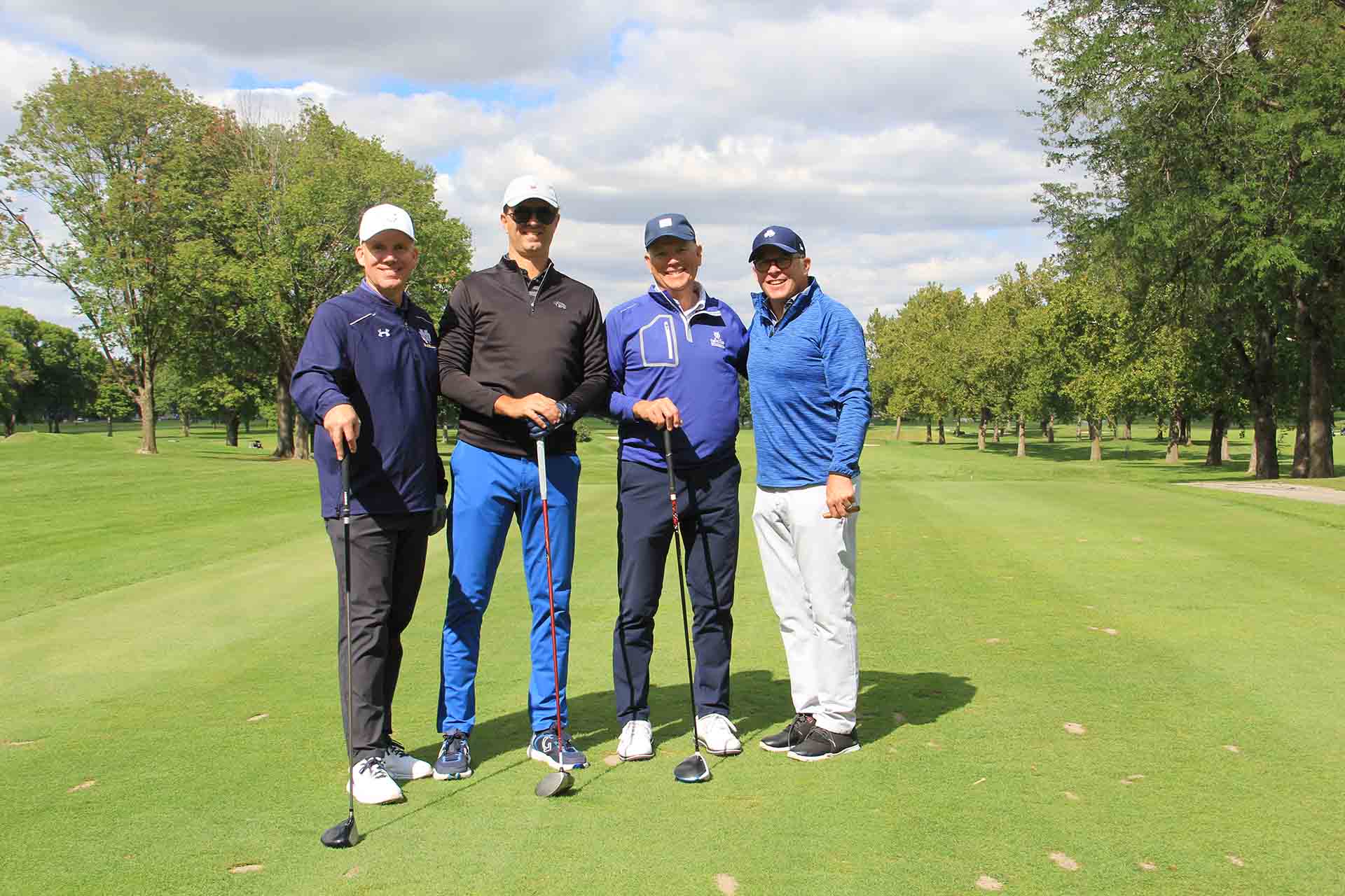 2022-Endowment-Golf-Classic-four-people-pose-on-golf-course