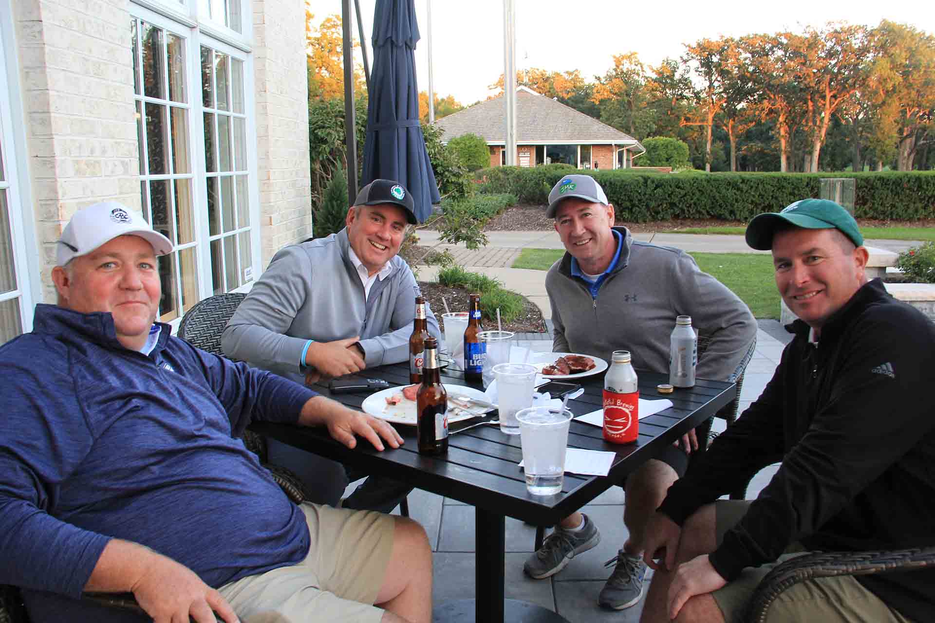 2022-Endowment-Golf-Classic-four-people-seated-at-smaller-table-smiling-for-photo