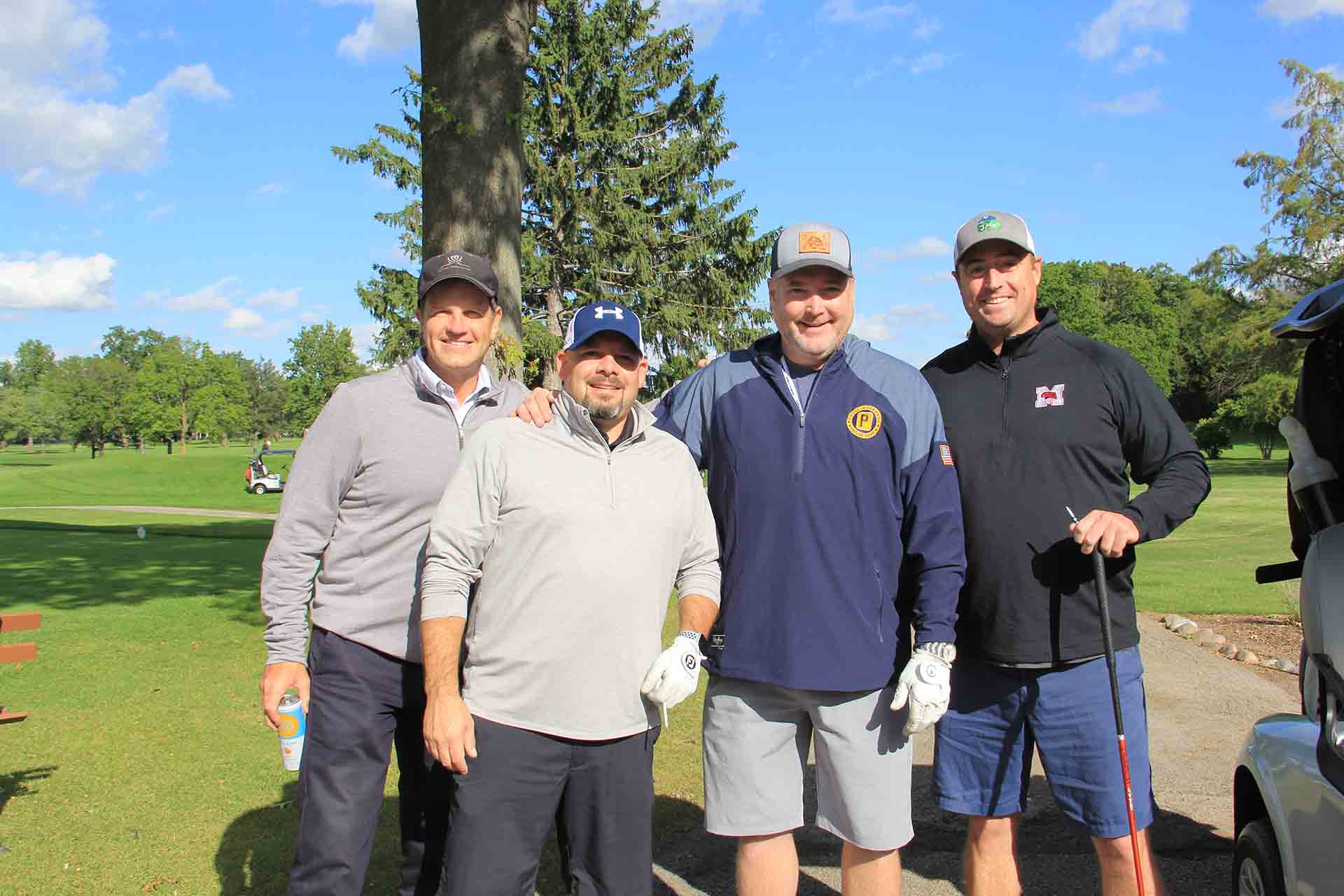 2022-Endowment-Golf-Classic-four-people-smile-by-tree