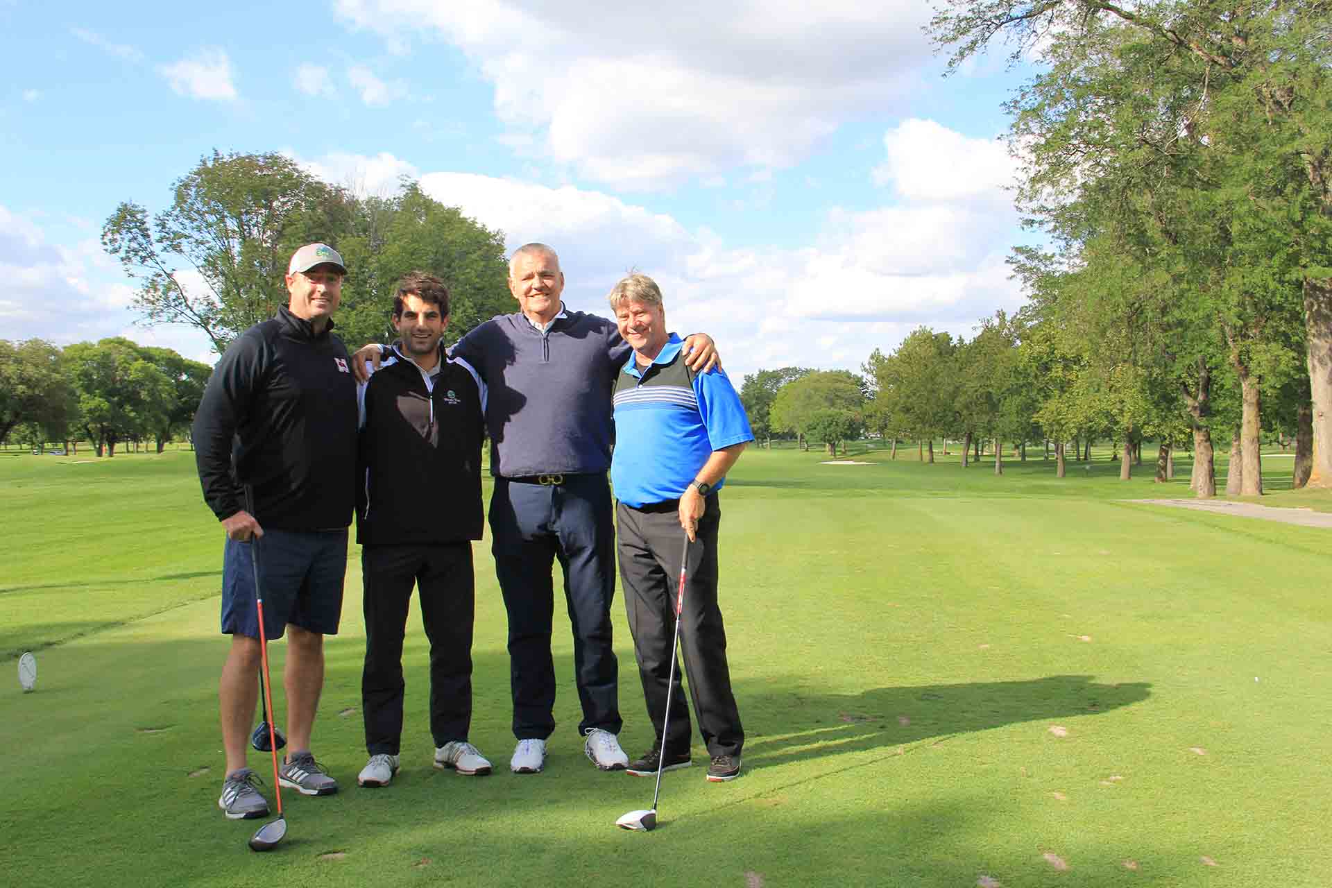 2022-Endowment-Golf-Classic-four-people-standing-for-group-photo-on-golf-course