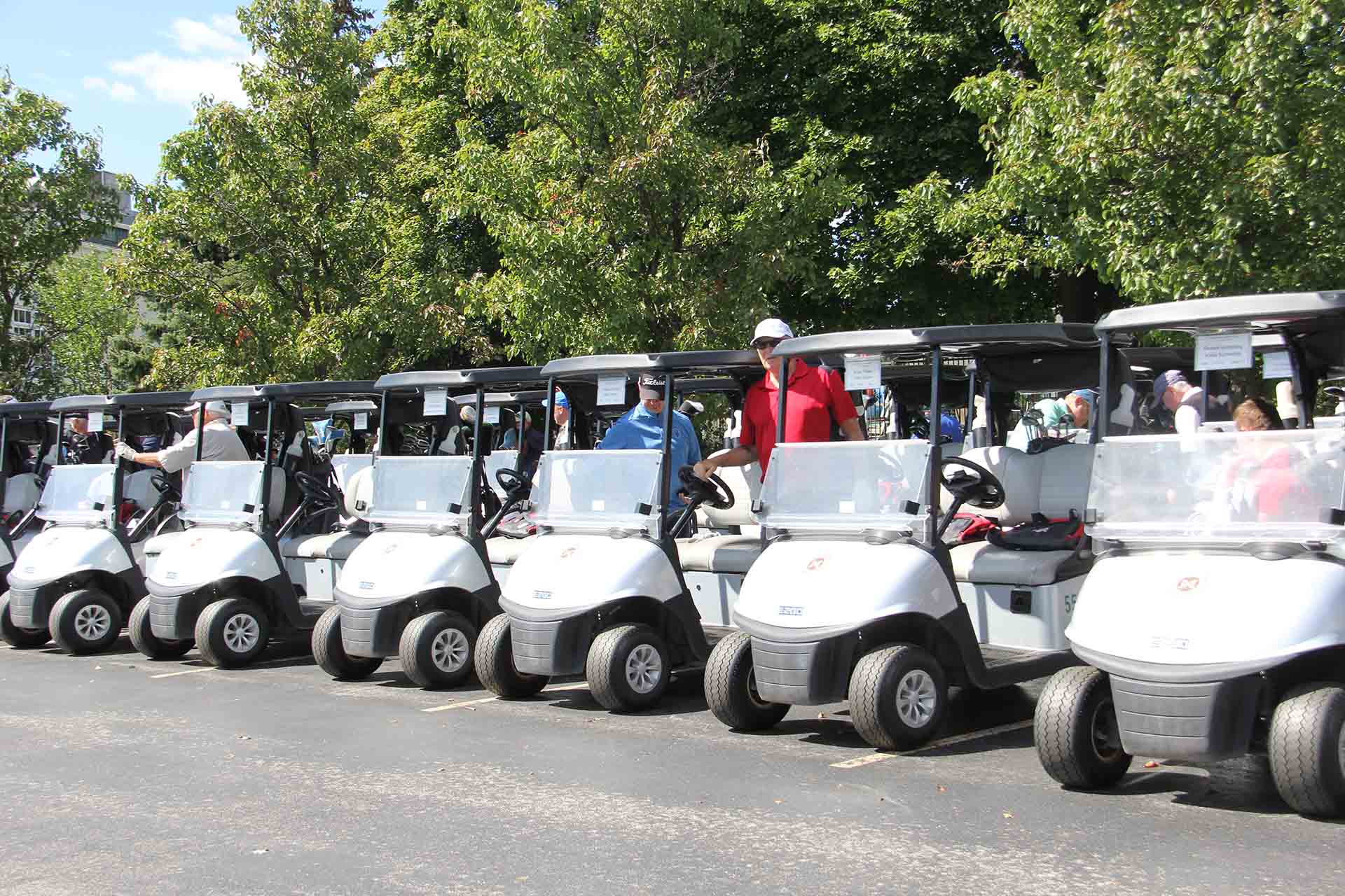 2022-Endowment-Golf-Classic-golf-carts-with-people-next-to-it