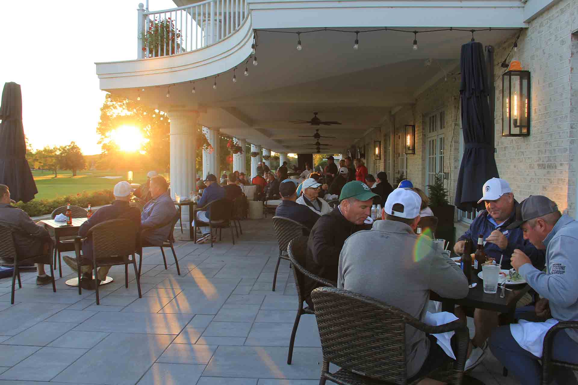 2022-Endowment-Golf-Classic-people-sitting-while-sun-goes-diwn