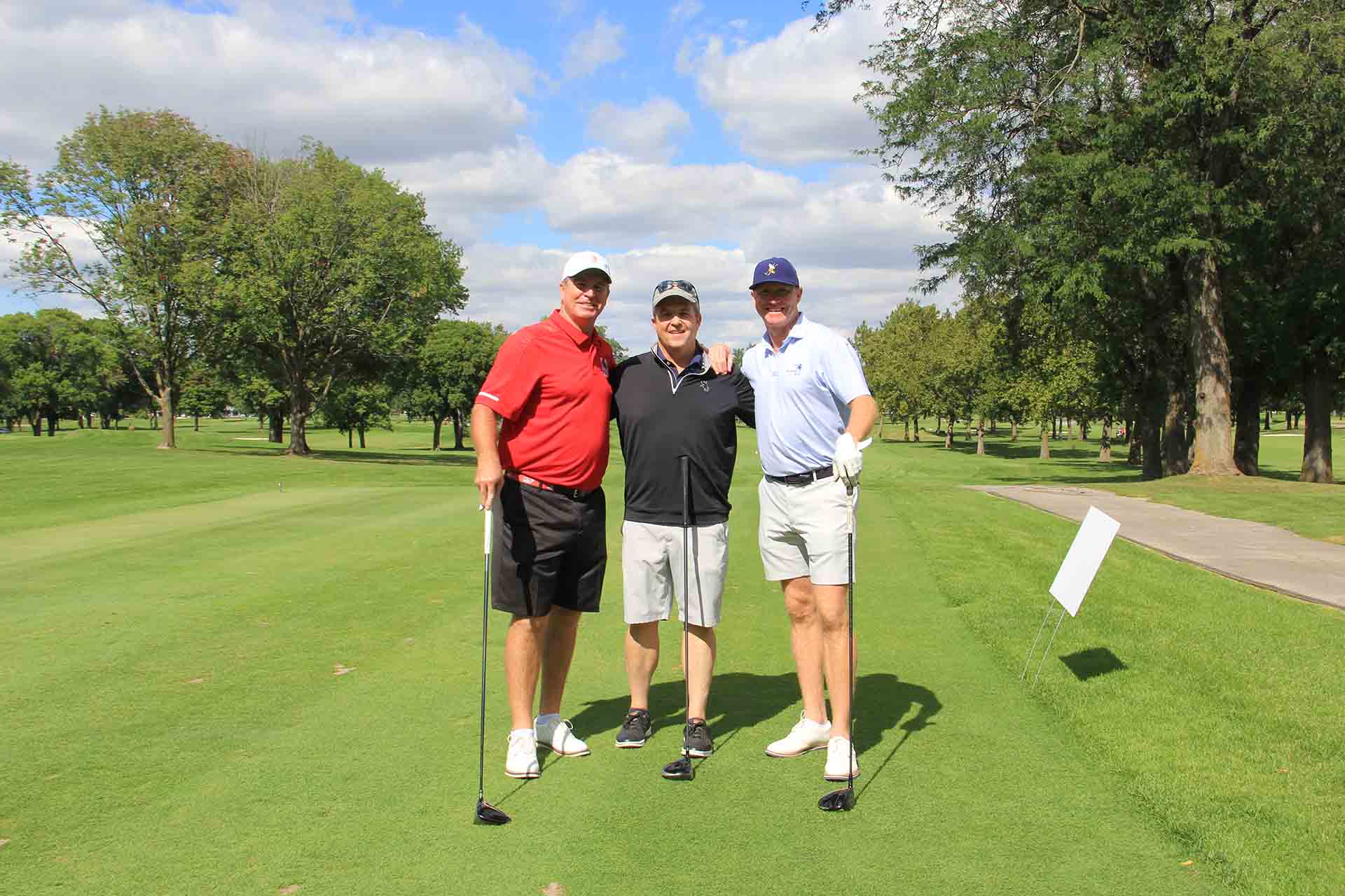 2022-Endowment-Golf-Classic-three-people-pose-on-golf-course