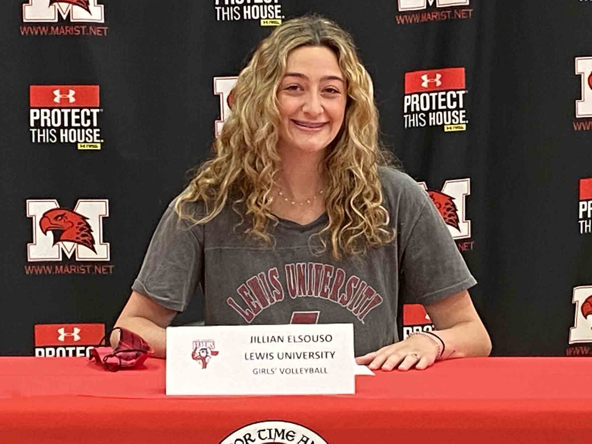 NLI-April-2021-person-wears-lewis-university-tshirt-while-signing