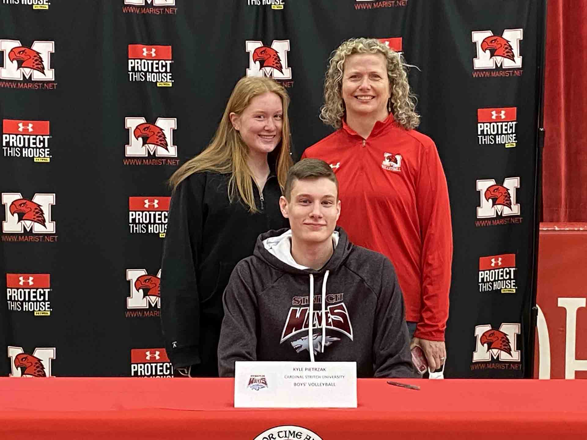 NLI-April-2021-person-with-family-smiles-at-signing