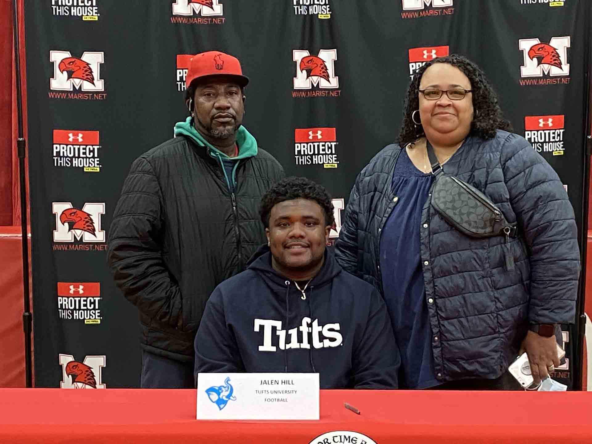 NLI-April-2021-student-with-tufts-hoodie-and-family