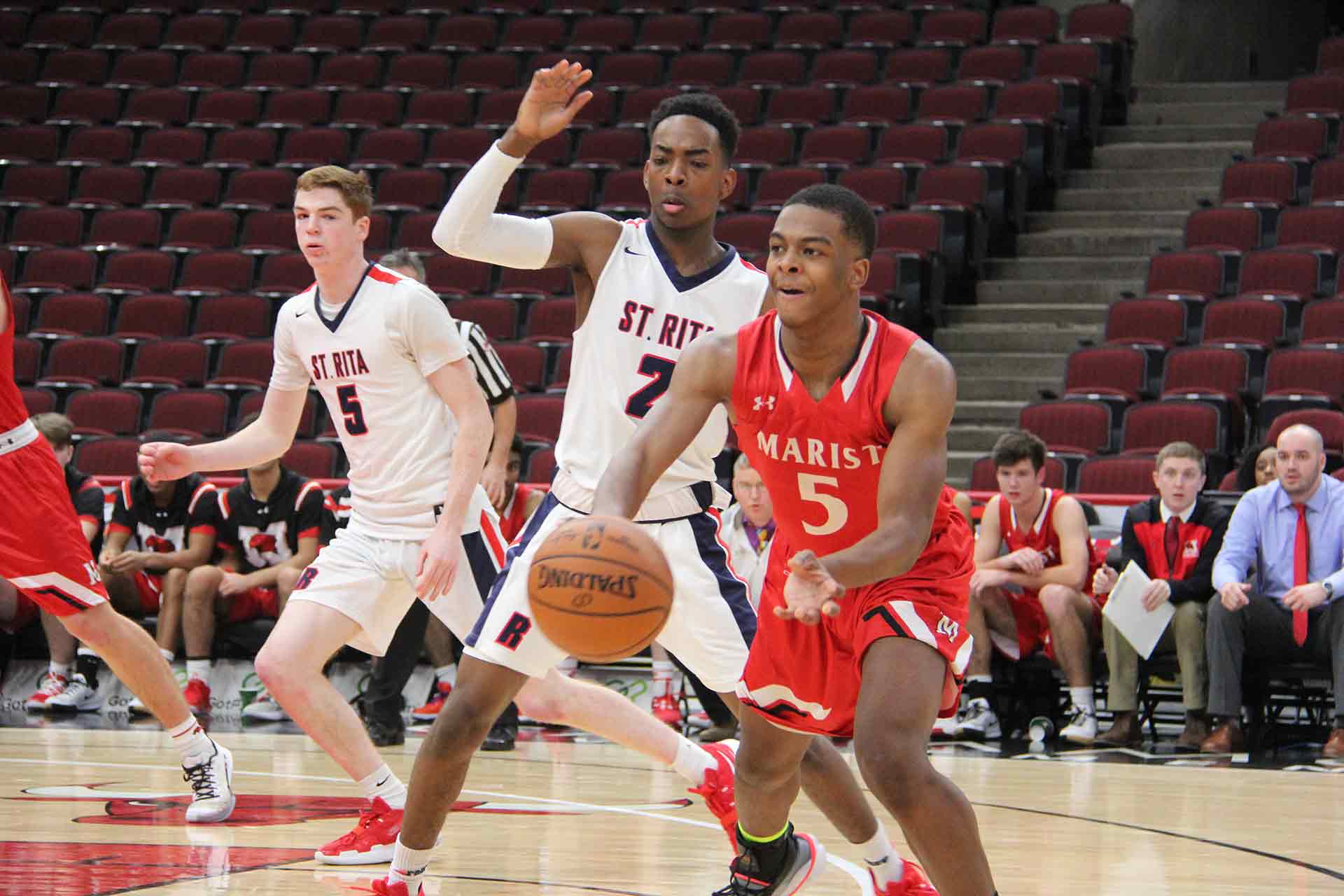 boys-basketball-vs-st-rita-marist-player-dribbling-with-opposing-team-behind