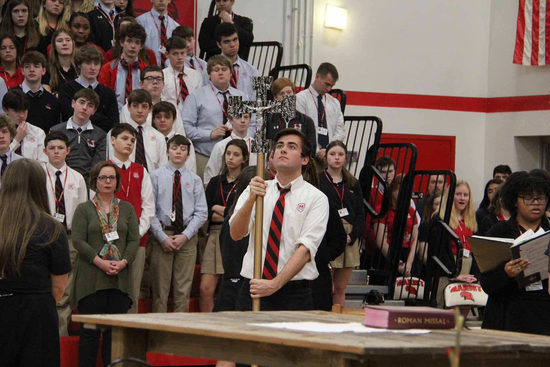 catholic-schools-week-mass-2020-male-student-holding-cross