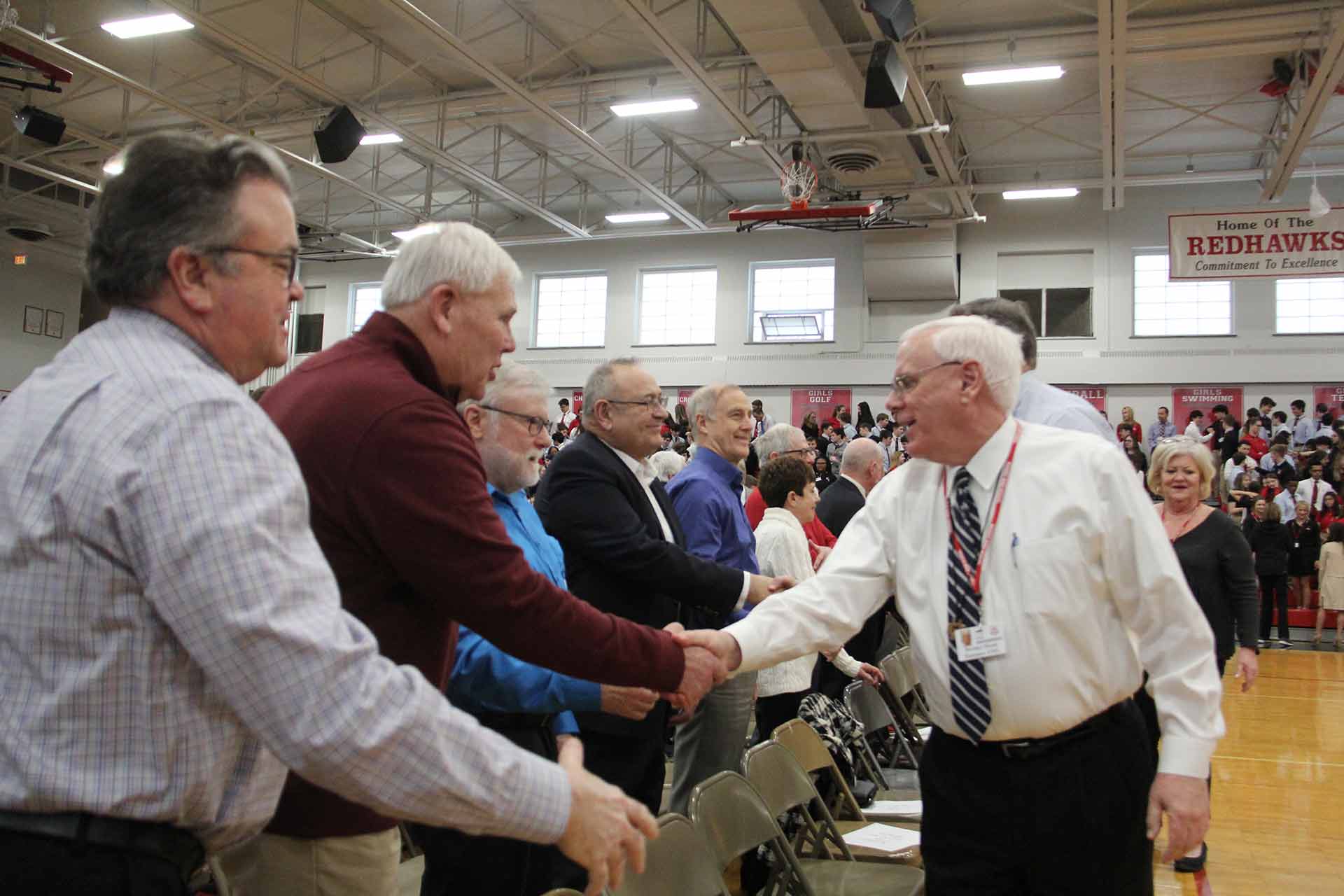 catholic-schools-week-mass-2020-men-shaking-hands