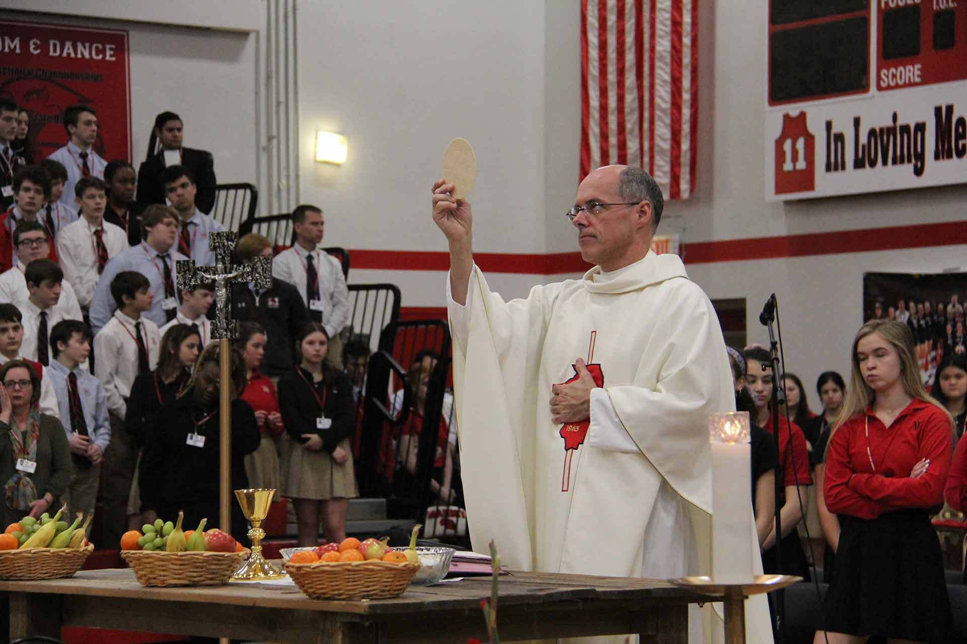 catholic-schools-week-mass-2020-priest-holding-bread