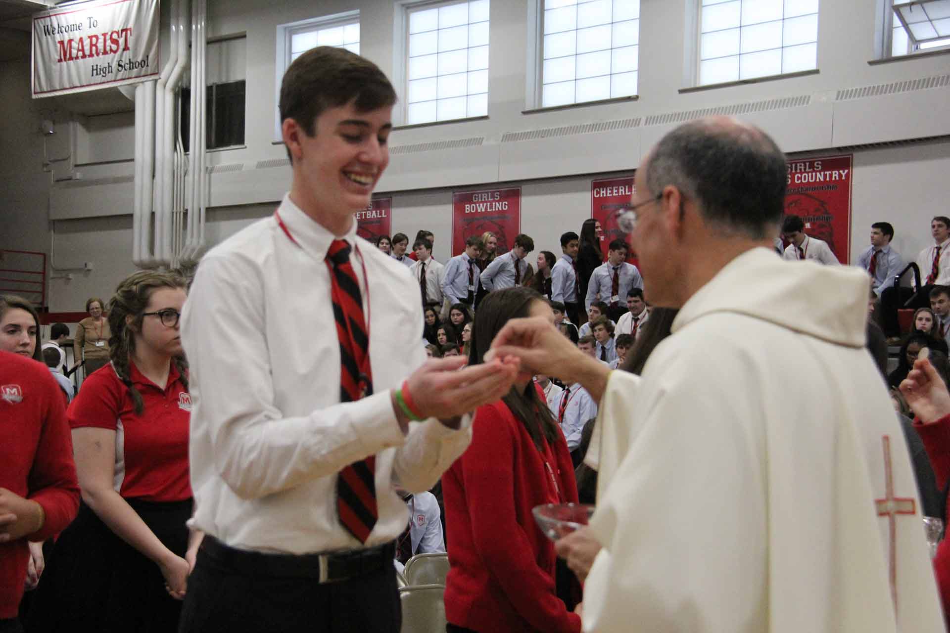 catholic-schools-week-mass-2020-student-smiling-while-recieving-communion