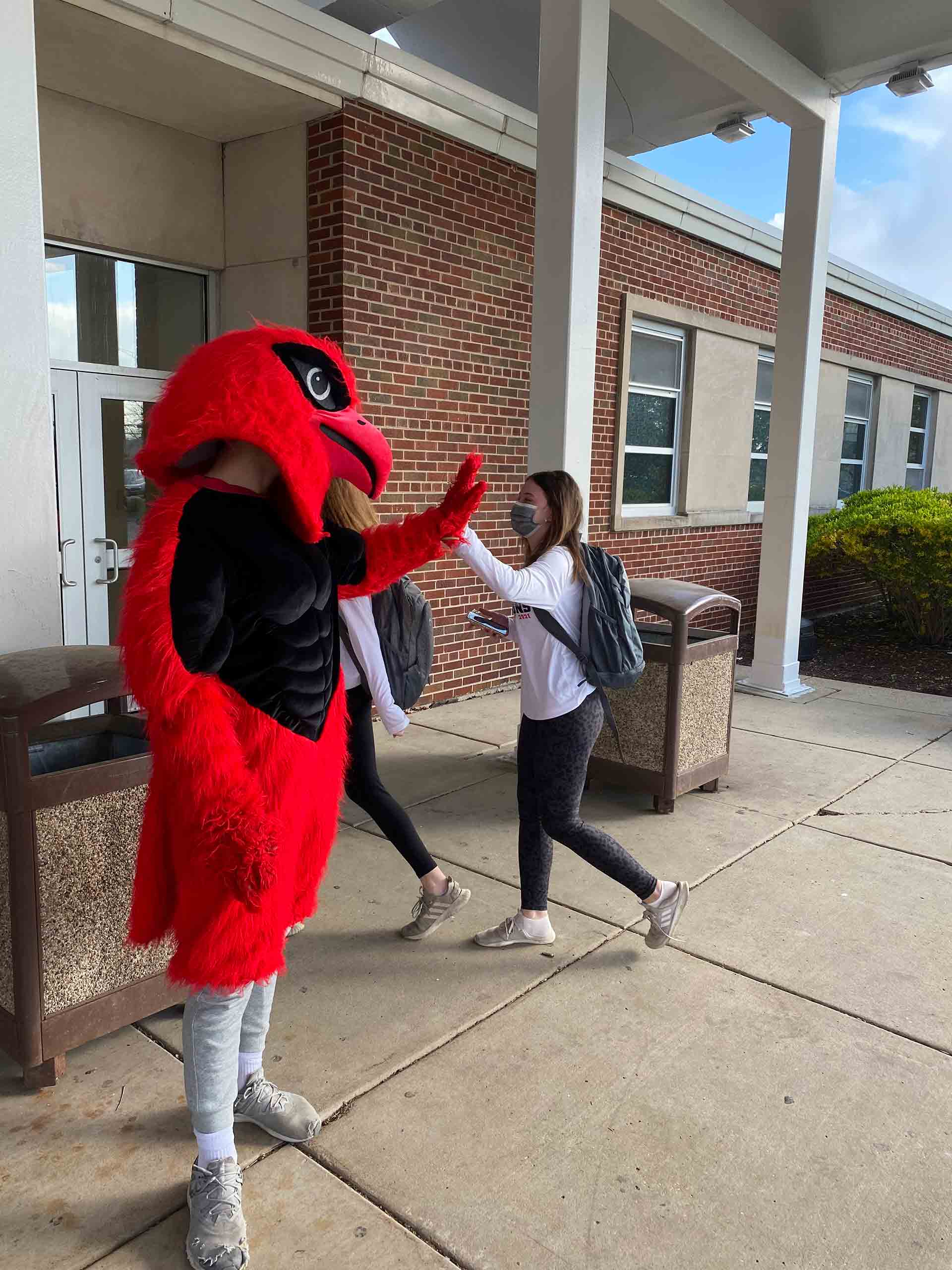champagnat-day-2021-mascot-high-five-two-students
