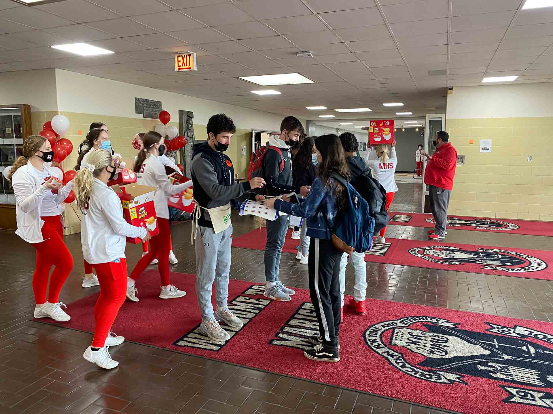 champagnat-day-2021-students-handing-each-other-objects