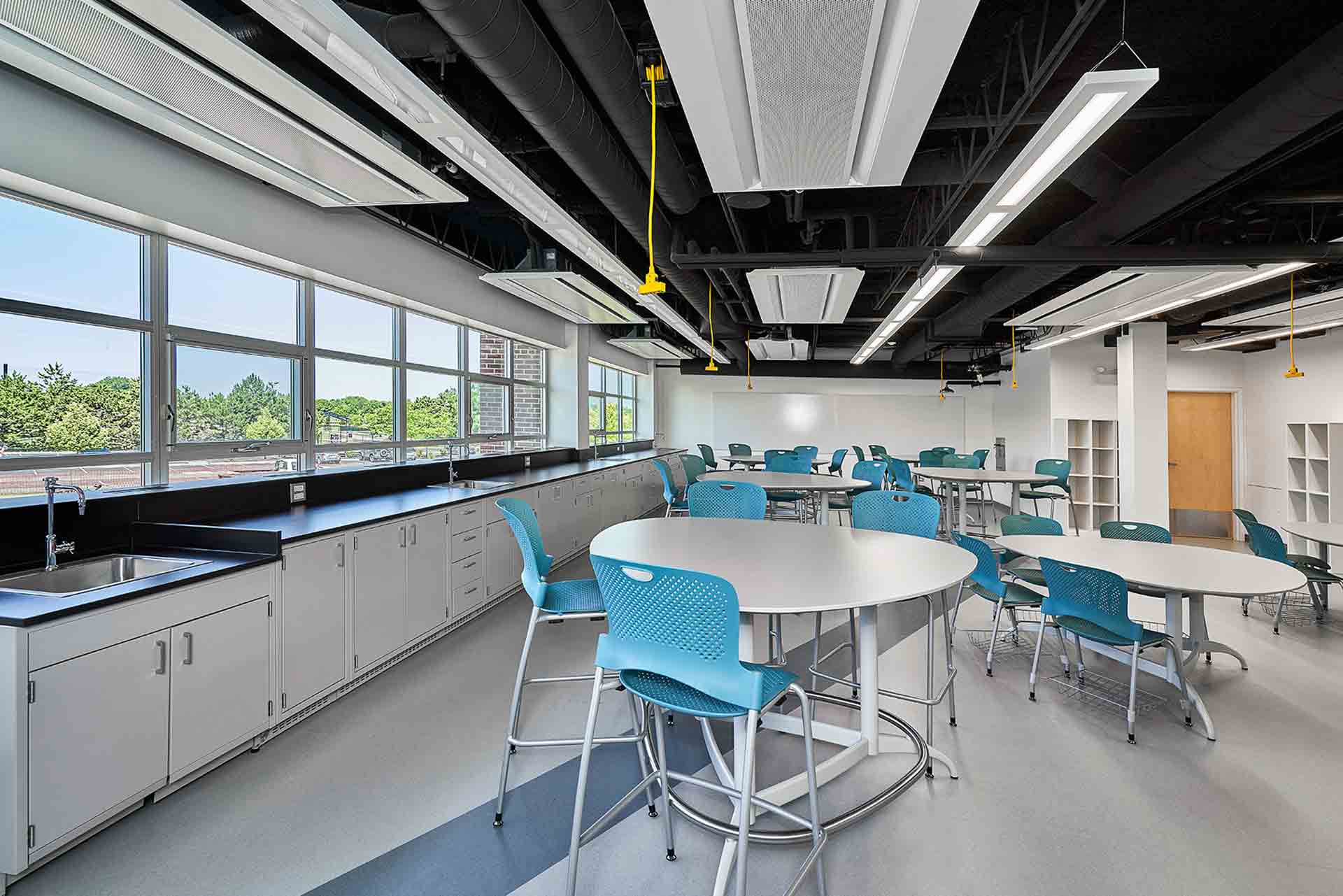 faith-in-the-future-campaign-classroom-with-round-tables-and-blue-chairs