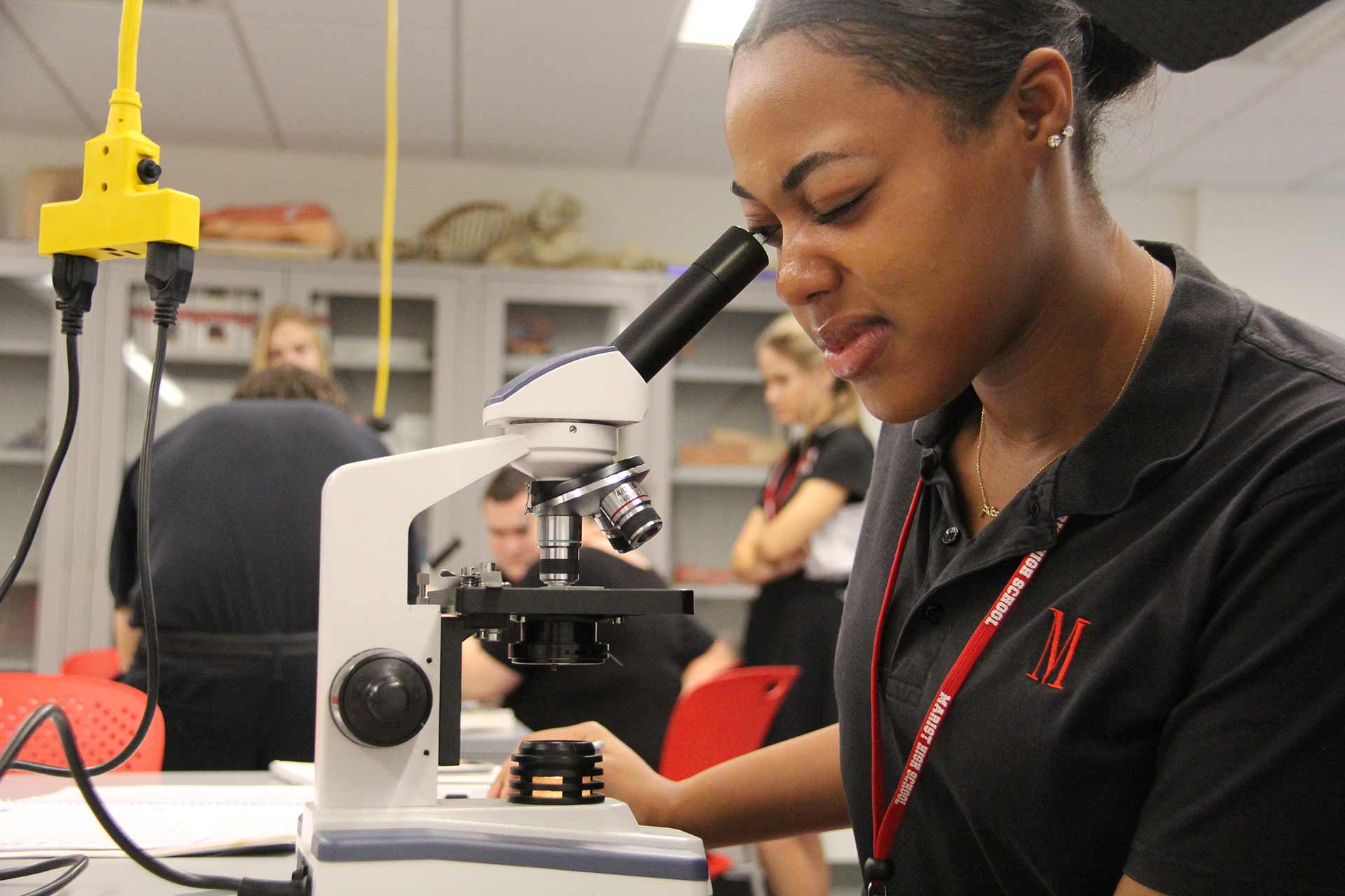 faith-in-the-future-campaign-student-looking-through-microscope