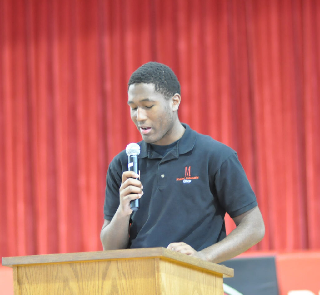 faith-student-speaking-on-podium-header