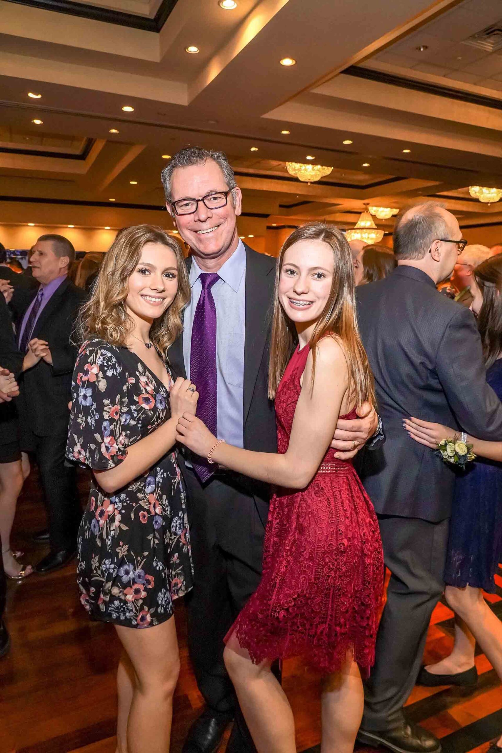 father-daughter-dance-2019-father-smiling-with-two-daughters