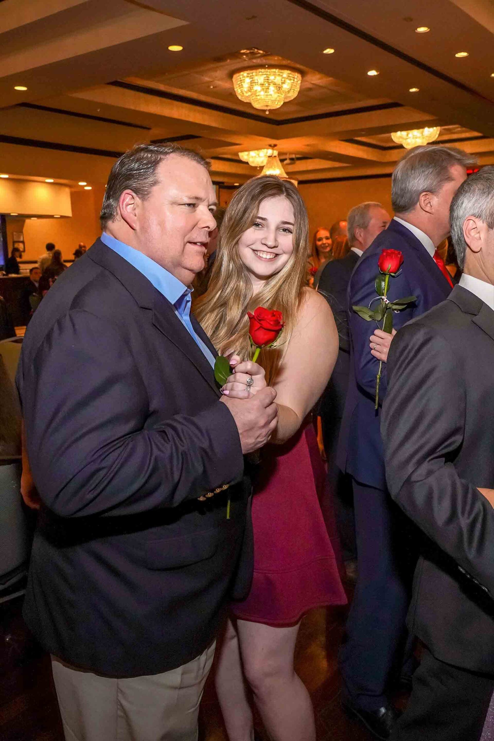 father-daughter-dance-2019-girl-smiling-with-rose