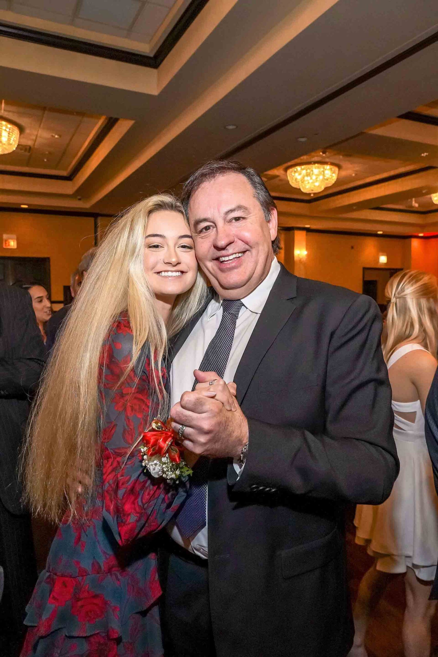 father-daughter-dance-2019-girl-with-red-flower-dress-smiling-with-father