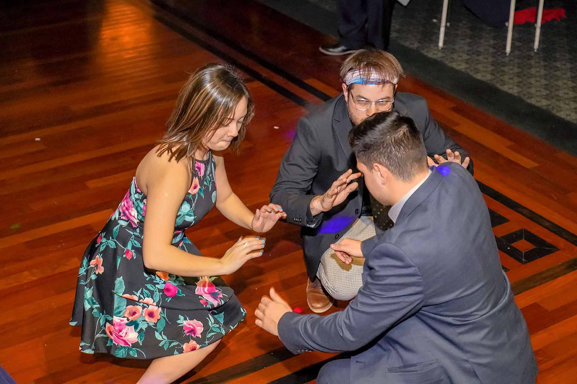 father-daughter-dance-2019-three-people-crouching-on-the-dance-floor