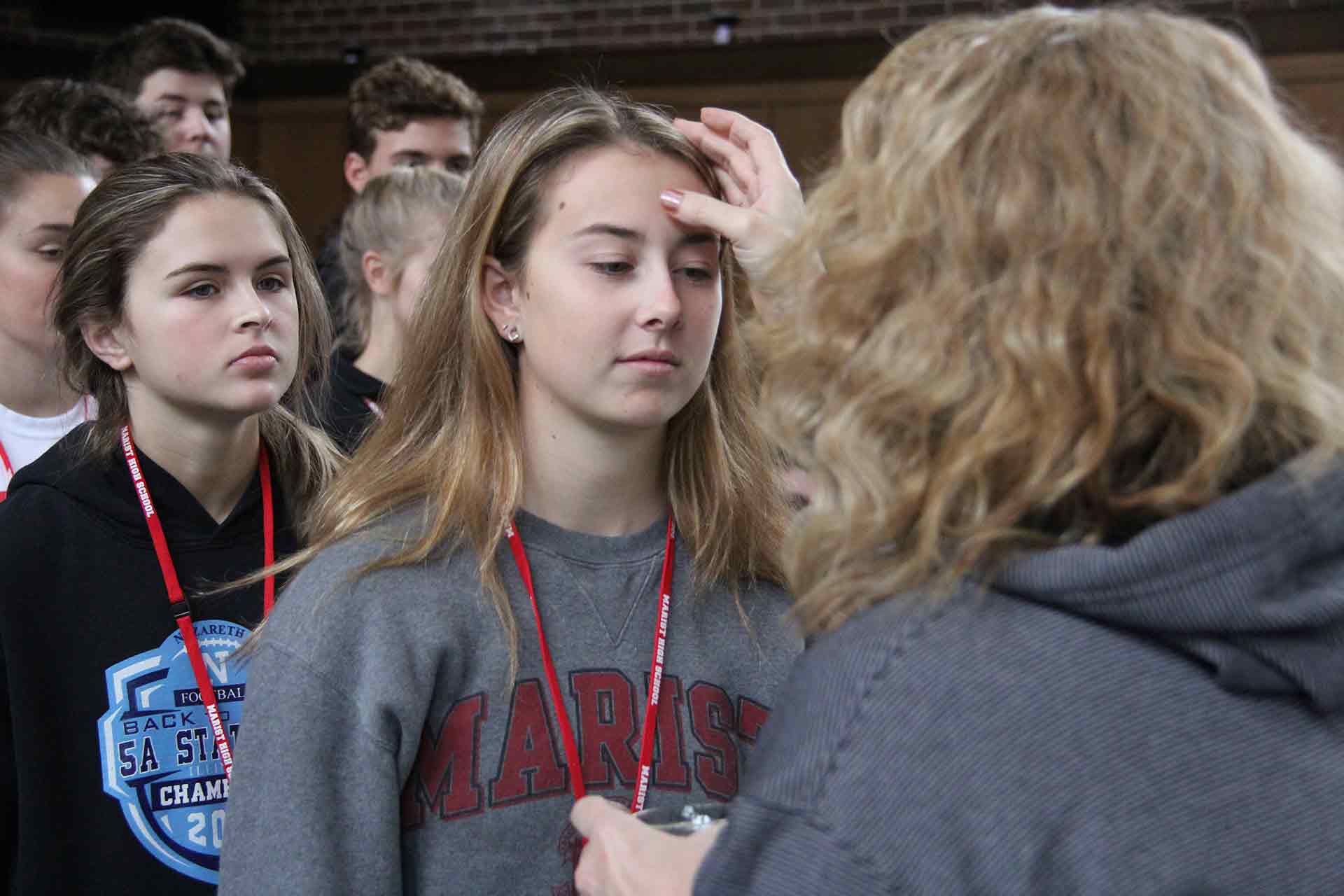 first-year-eperience-and-retreat-close-up-of-student-recieving-blessing