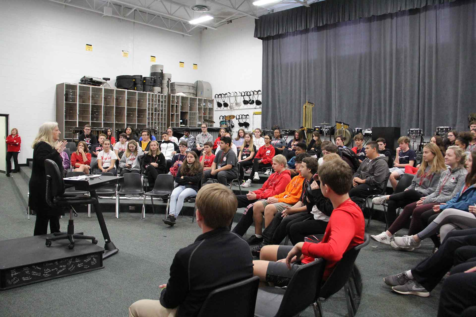 first-year-eperience-and-retreat-teacher-talking-to-students-in-band-room