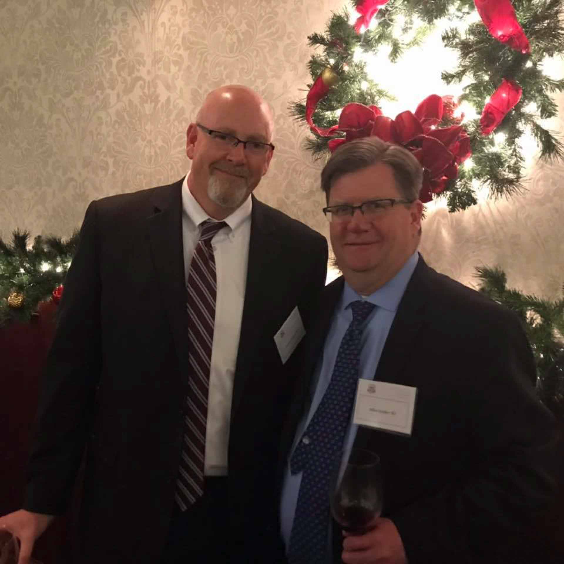 law-association-christmas-social-2019-two-people-smile-in-front-of-reef