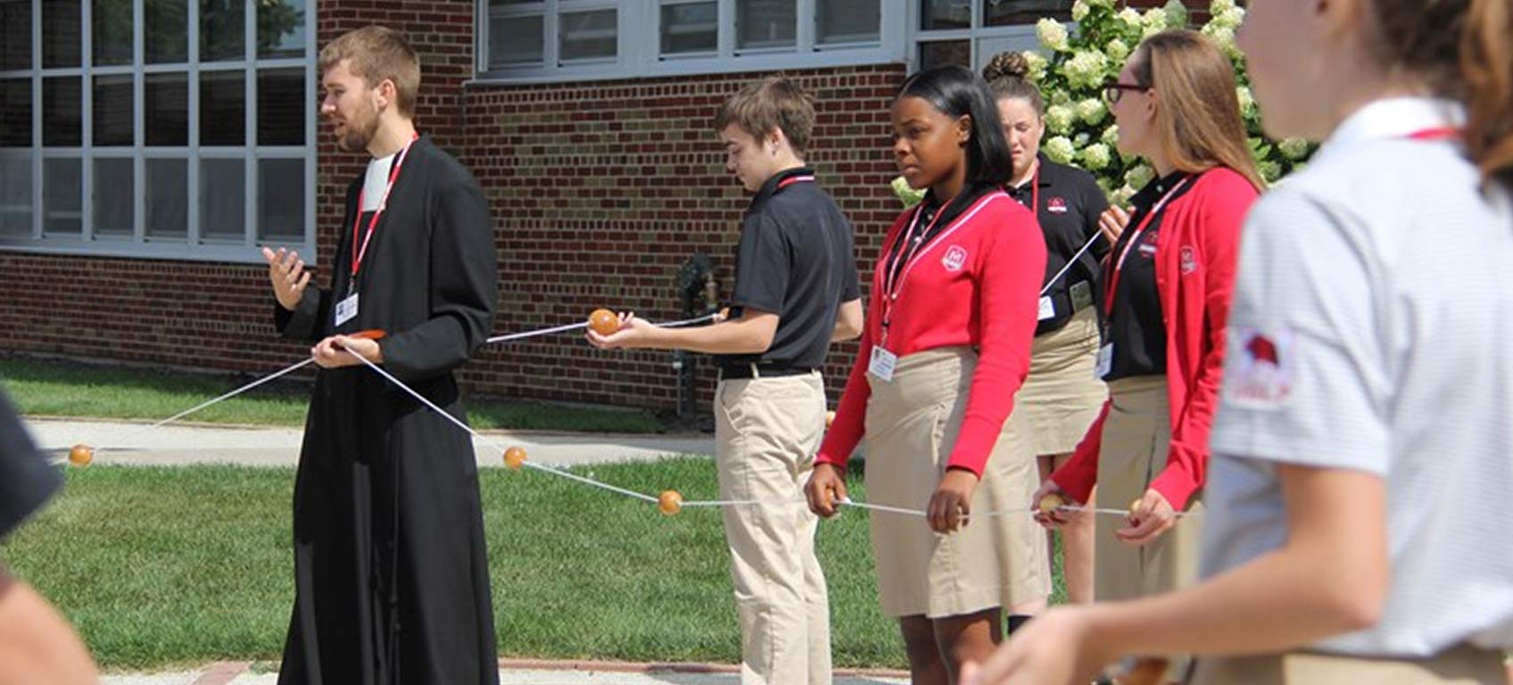 marist-pillars-priest-with-students