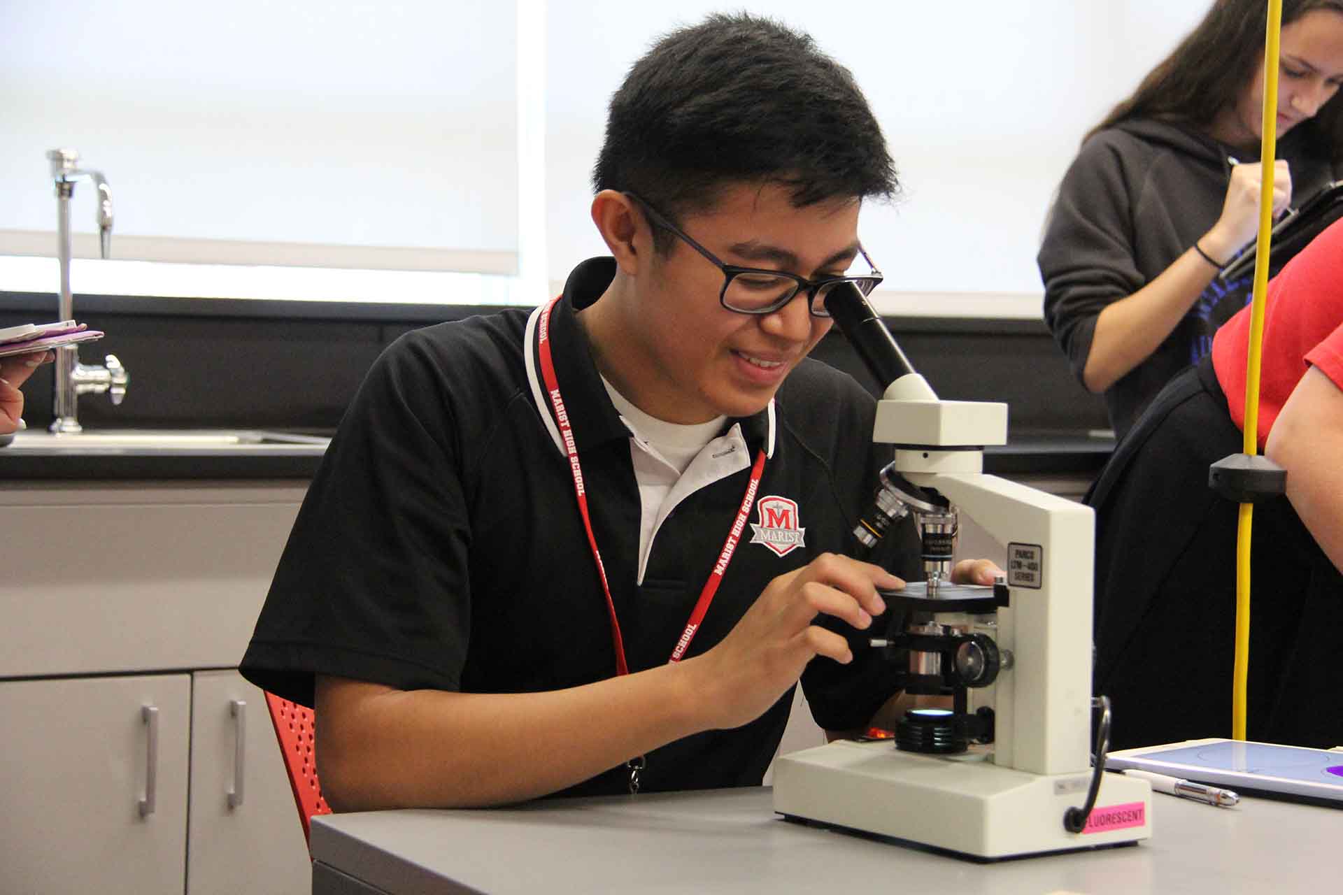 marist-science-wing-student-looks-through-microscope