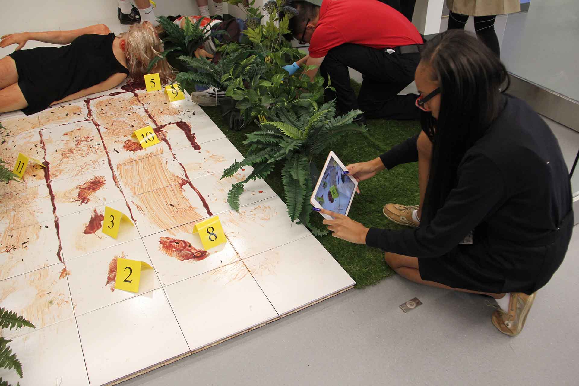 marist-science-wing-students-examine-crime-scene-take-pictures-with-ipad