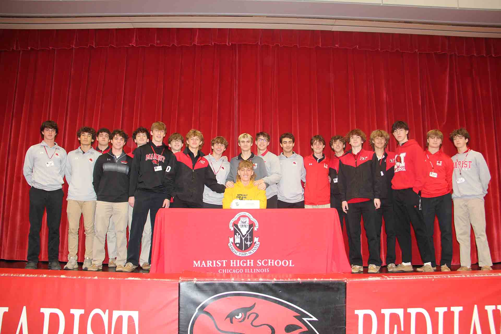 marist-students-with-student-signing-to-college-for-group-photo