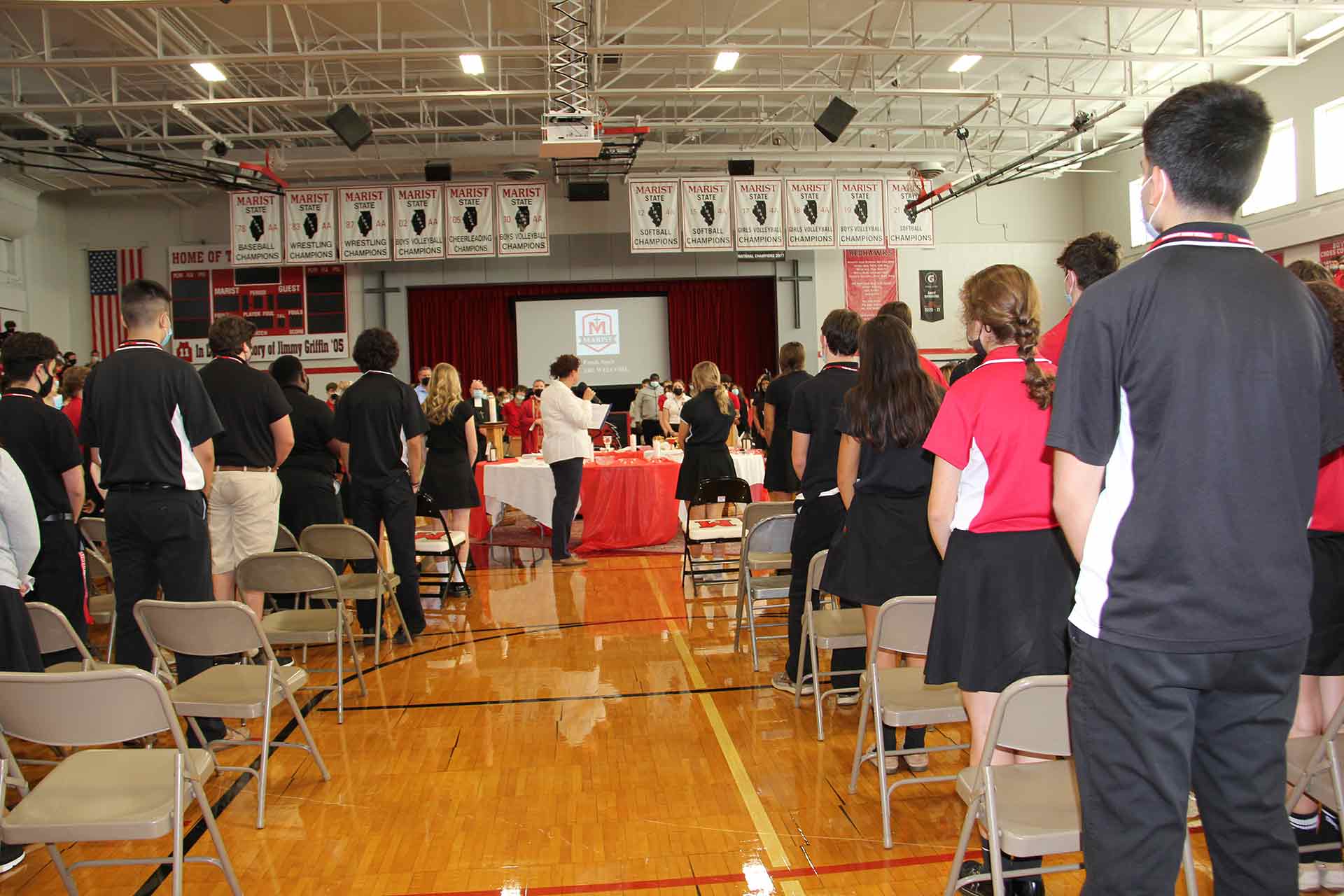 school-mass-9-15-2021-students-standing-up-for-mass-in-gym