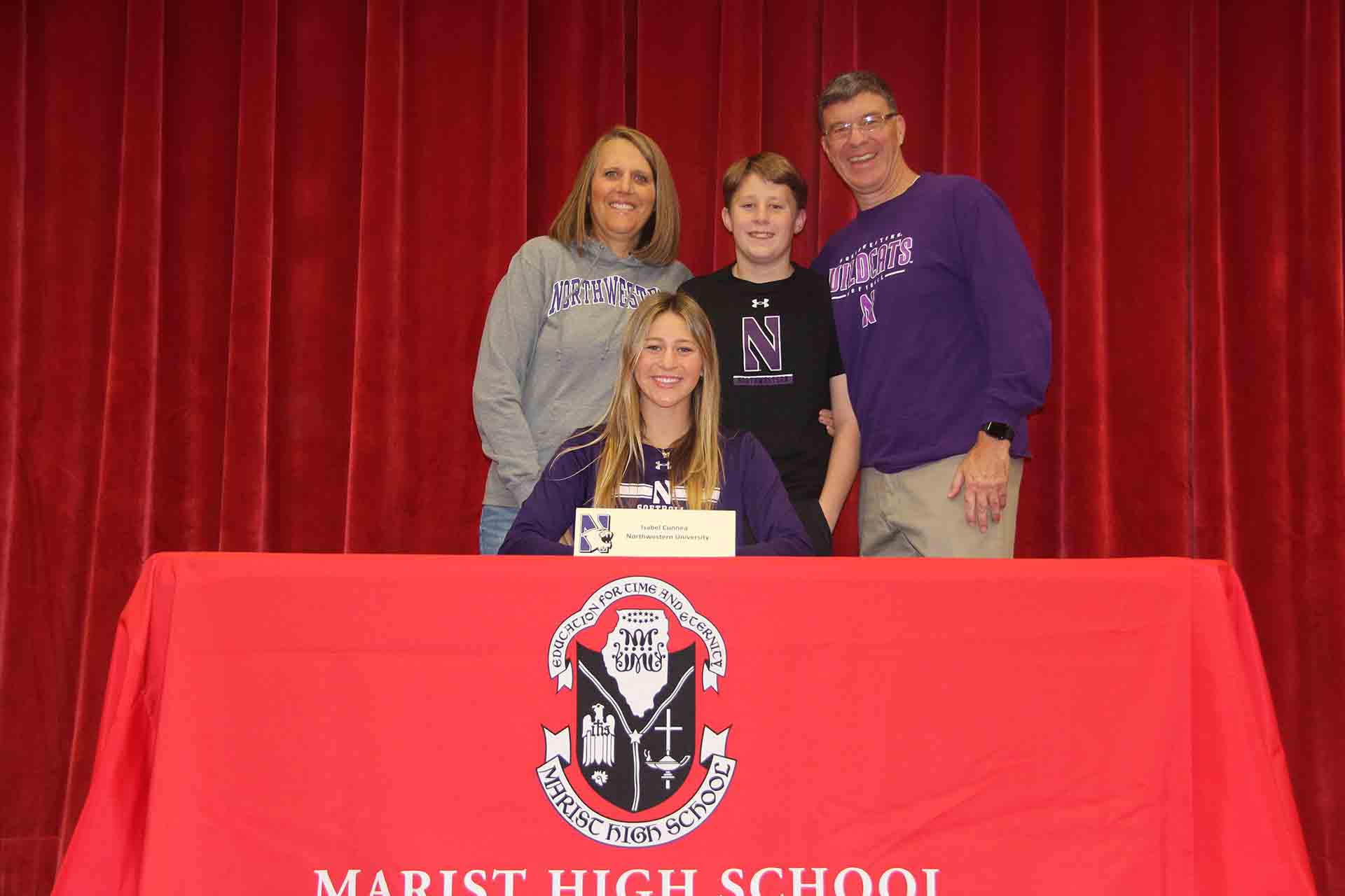 student-signs-to-northwestern-university-with-family-supporting