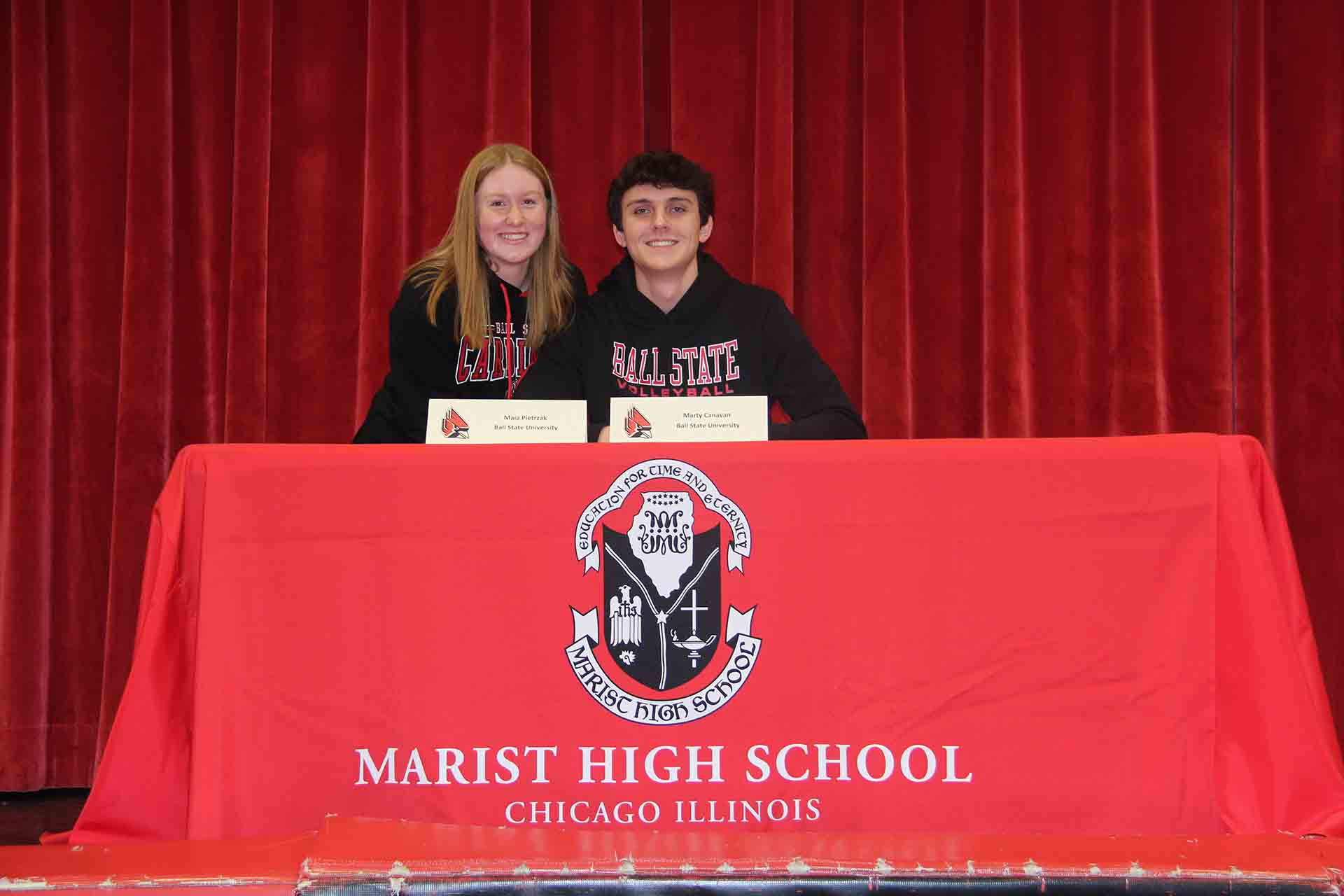 two-students-smile-while-signing-to-ball-state